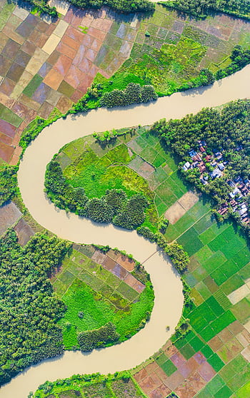 Explore the vibrant aerial landscape of Banten, Indonesia, showcasing lush farmland and winding river. HD phone wallpaper