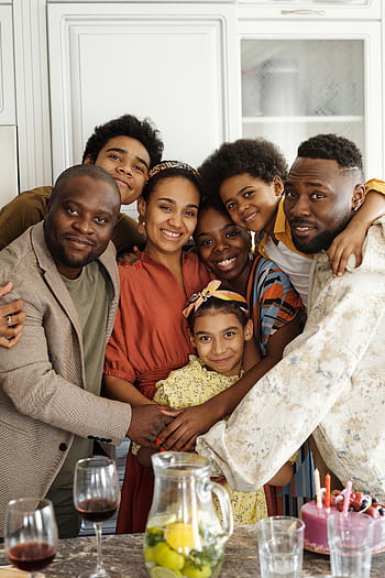 Happy family gathering in a cozy kitchen, celebrating with joy and love. HD phone wallpaper