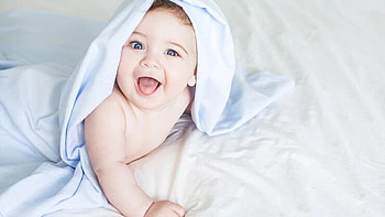 Laughing Newborn Boy Toddler Is Lying Down On White Bed Covering With Towel Cute HD wallpaper
