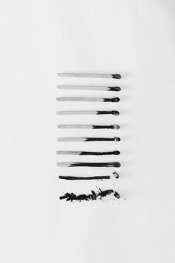 Artistic black and white of burned matches arranged on a white background, symbolizing burnout. HD phone wallpaper