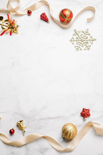 Elegant Christmas decorations arranged on a marble surface with ample copy space. HD phone wallpaper