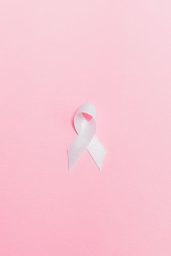A pink ribbon symbolizing breast cancer awareness set against a light pink background. HD phone wallpaper