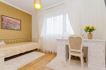 Elegant minimalist bedroom with white furniture and warm decor accents. HD wallpaper