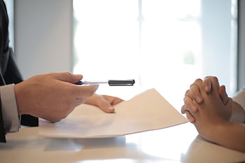 Close-up of a contract signing with hands over documents. Professional business interaction. HD wallpaper