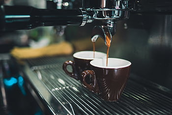 Close-up of a professional espresso machine brewing coffee into cups. HD wallpaper