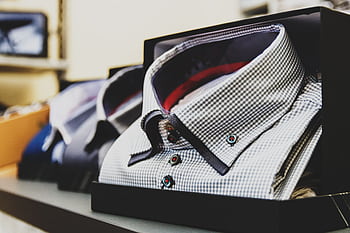 Set of formal checkered shirts neatly packed in boxes, ideal for business or gift. HD wallpaper