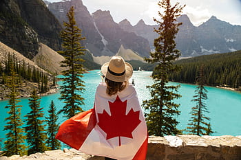 Explore the beauty of Moraine Lake in Alberta, Canada, with a stunning view and a Canadian flag. HD wallpaper