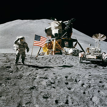 Astronaut on the moon near lunar module and American flag during historic landing. HD phone wallpaper