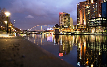 city riverfront at dusk, river, city, lights, bridge, dusk, banks HD wallpaper