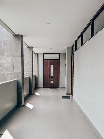Bright and clean modern hallway in a minimalist apartment, capturing sunlight and shadows. HD phone wallpaper
