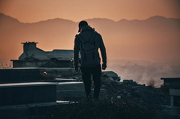 Silhouette of a backpacker exploring ruins at sunset in Kabul, Afghanistan. HD wallpaper