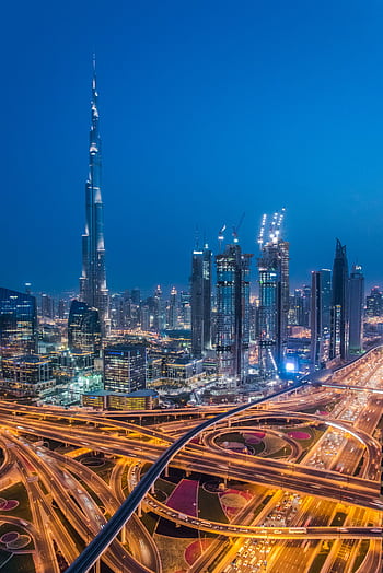 A breathtaking aerial view of Dubai's skyline with Burj Khalifa lit at night. HD phone wallpaper