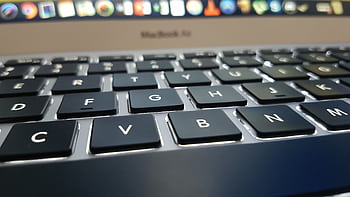 Detailed view of a MacBook Air keyboard with focus on keys, emphasizing technology and design. HD wallpaper
