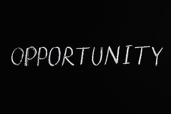 Word 'Opportunity' written in chalk on a black chalkboard, symbolizing new possibilities. HD wallpaper