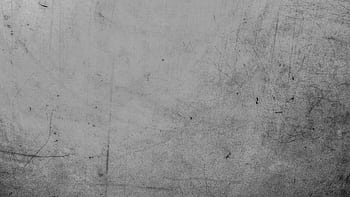 Detailed view of a textured grey surface with visible scratches and marks. HD wallpaper