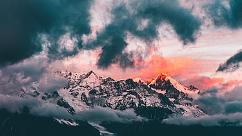 Clouds, sunset, glowing peaks, mountains HD wallpaper