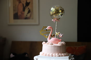 Elegant pink birtay cake with flamingo and balloon decorations indoors. HD wallpaper