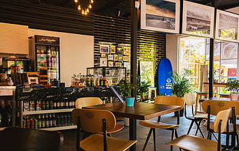 Stylish café interior with modern decor and natural lighting, located in Sochi, Russia. HD wallpaper