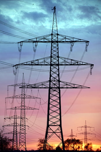 Electricity pylons silhouetted against a dramatic sunset sky, showcasing high voltage transmission. HD phone wallpaper