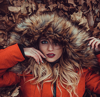 Woman in hood, dry, brown leaves HD wallpaper
