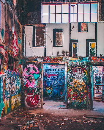 Colorful street art covers the walls of an abandoned building, showcasing vibrant graffiti. HD phone wallpaper