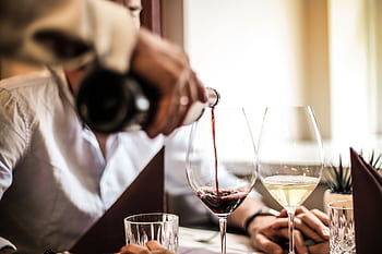 Close-up of wine being poured during an elegant romantic dinner setting with two people. HD wallpaper