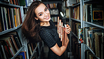 Smiling Girl Model Is Wearing Black Dress Standing In Between Bookshelves With Books Girls HD wallpaper