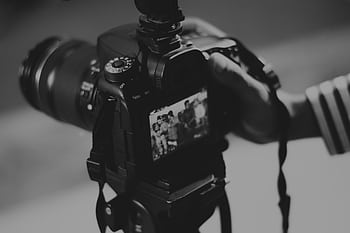 Black and white of a DSLR camera capturing people in focus, showcasing graphy professionalism. HD wallpaper