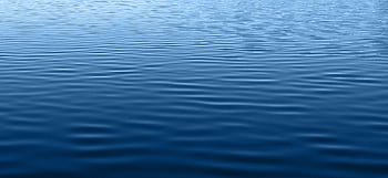 A calm blue water surface with gentle ripples, creating a soothing texture. HD wallpaper