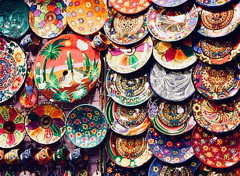 A colorful array of handmade pottery and ceramics displayed at a Dubai market. Ideal for art and craft enthusiasts. HD wallpaper