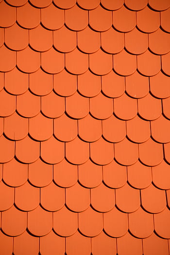 Bright orange roof tiles arranged in a seamless repetitive pattern, perfect for backgrounds and designs. HD phone wallpaper