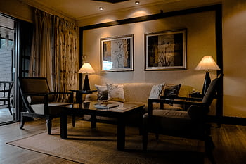 Stylish and cozy living room featuring elegant furniture and warm lighting. HD wallpaper