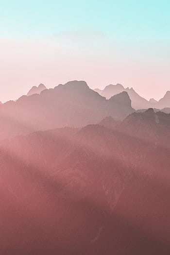 Peaceful pastel mountain landscape with soft light at sunrise, evoking tranquility. HD phone wallpaper