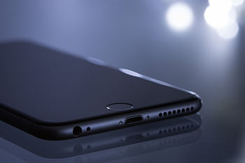 Close-up of a sleek smart with a blurred bokeh reflection, showcasing modern technology design. HD wallpaper