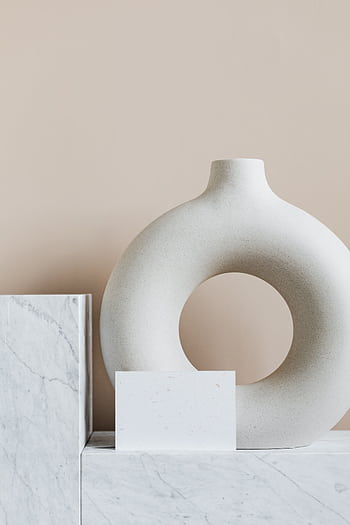 Explore elegance with a minimalist design featuring marble surfaces and a unique ceramic vase. HD phone wallpaper