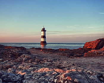 Lighthouse in the Water, sea, shore, lighthouse, stone, nature, beach HD wallpaper