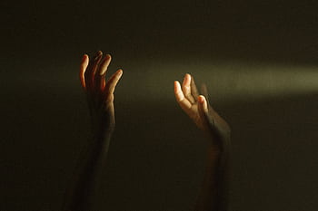 Expressive hands reaching towards a ray of light symbolize hope and mental resilience. HD wallpaper