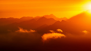 Sun Setting Over A Mountain Range Dark Evening, nature, clouds, sky, sea, ocean, sun, sunset HD wallpaper