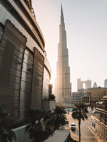Captivating view of the iconic Burj Khalifa at sunrise in downtown Dubai, showcasing architectural grandeur. HD phone wallpaper