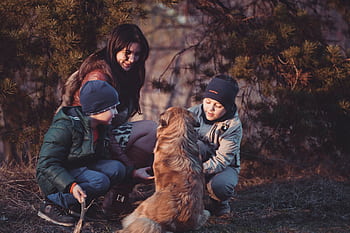 A family with two children and their dog enjoying an autumn day outdoors in nature. HD wallpaper