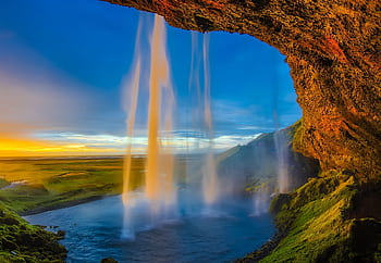 Magnificent view of Seljalandsfoss waterfall in Iceland against a stunning sunset sky. HD wallpaper