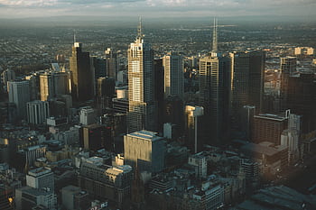 High-angle cityscape of Melbourne's skyline with modern skyscrapers at dusk. HD wallpaper