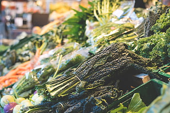 A vibrant display of fresh organic vegetables at a local market stall, showcasing healthy eating. HD wallpaper