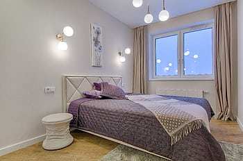 Stylish modern bedroom with purple accents and elegant lighting. HD wallpaper