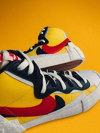 High-top sneakers with vibrant colors on a striking yellow backdrop. HD phone wallpaper