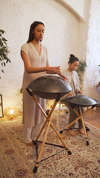 Women playing handpan drums, stock video, Harmony in motion, Melodic performance HD phone wallpaper