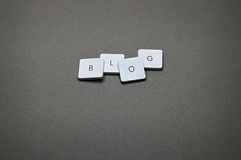 White Scrabble tiles spelling 'Blog' against a minimalist gray background. HD wallpaper