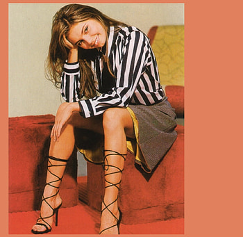 Alina Kabaeva, VERTICAL WHITE AND BLACK, GREY SKIRT, YELLOW UNDER SKIRT, STRIPED BLOUSE, SITTING ON CHAIR ARM, DARK BLONDE, ROMAN STYLE HEELS, ARM CHAIR HD wallpaper