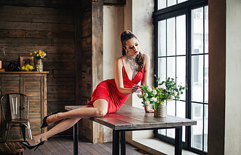 The Girl In The Red Dress Sitting On A Table Touching Flowers, red-dress, girls, model HD wallpaper
