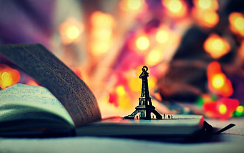 mood toys statue eiffel tower book book notebook notebook lights bokeh background full screen HD wallpaper